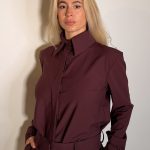 Camicia dal taglio dritto, collo classico a punta. Maniche lunghe caratterizzate da una coulisse regolabile con bottone .La chiusura con abbottonatura nascosta preserva la pulizia del design, perfetta da indossare in completo con il pantalone coordinato per un total look in nuance dal eleganza contemporanea.