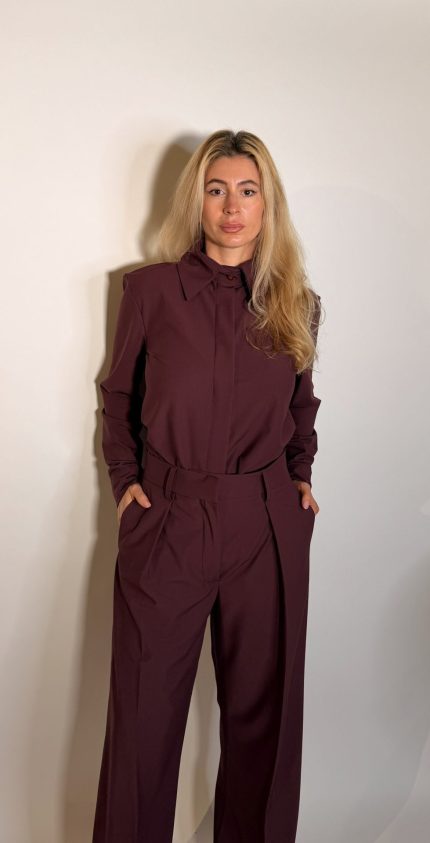 Camicia dal taglio dritto, collo classico a punta. Maniche lunghe caratterizzate da una coulisse regolabile con bottone .La chiusura con abbottonatura nascosta preserva la pulizia del design, perfetta da indossare in completo con il pantalone coordinato per un total look in nuance dal eleganza contemporanea.